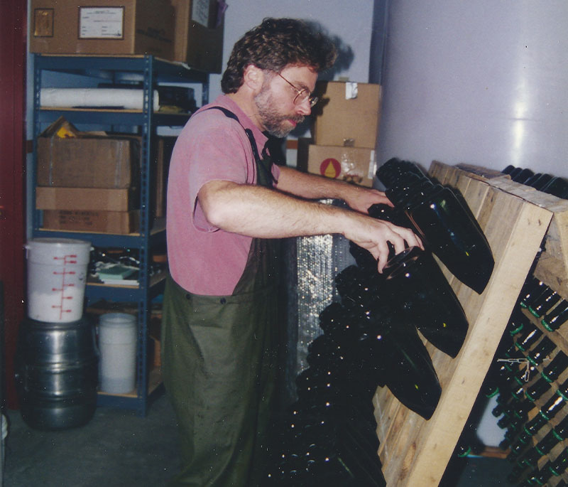 Mark Vlossak riddling wine bottles for sparkling wine