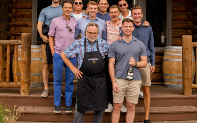 Mark standing with a group of young men outside of the St. Innocent Winery